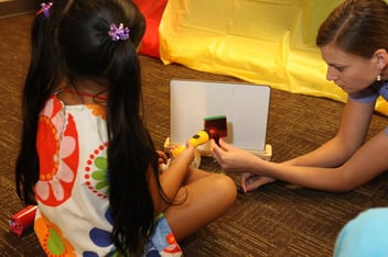 A young girl works with a professional