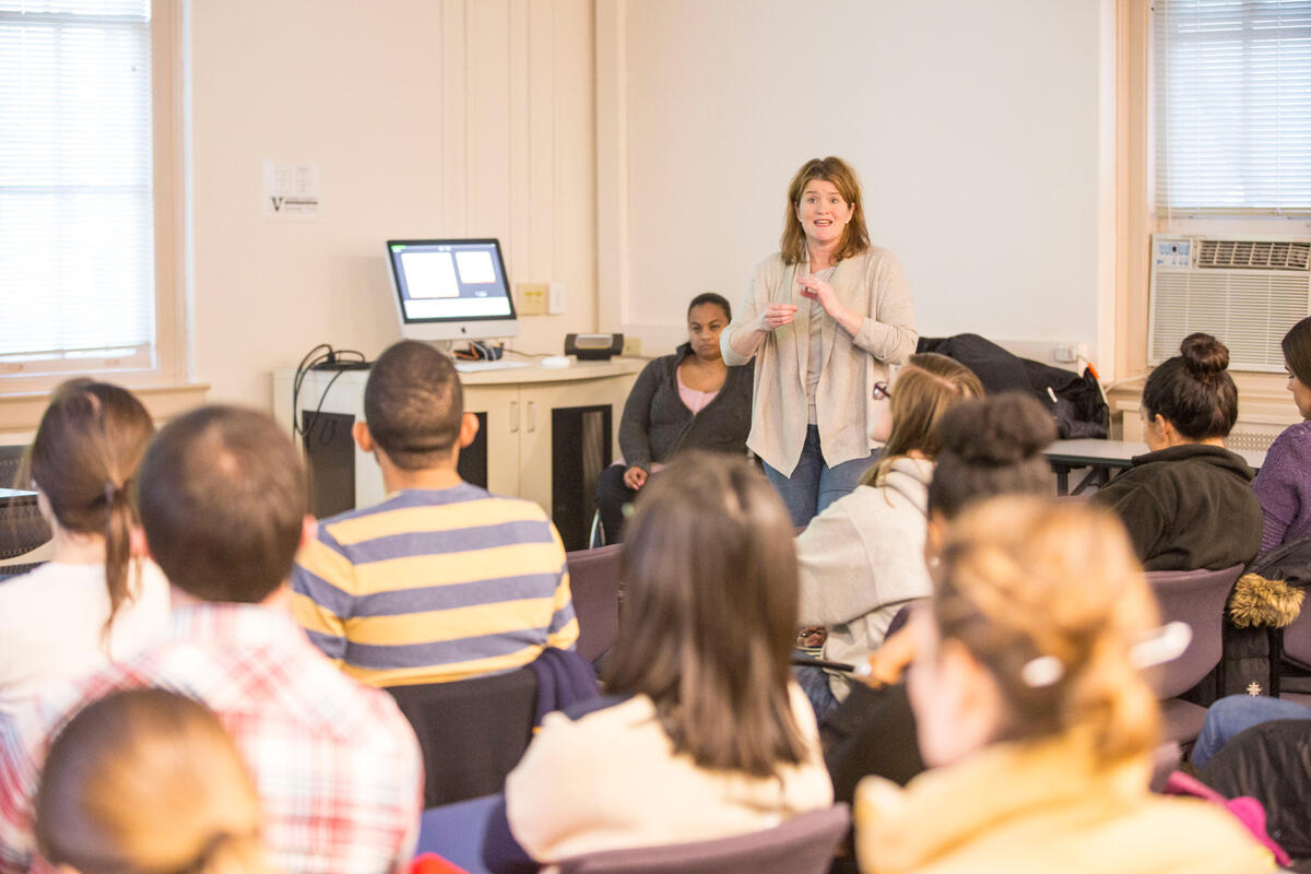 A woman giving a presentation to a group of people.