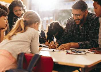 Group of elementary school kids having an art lesson with their teacher 